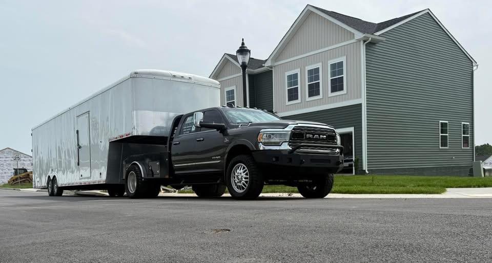 Cross country moving truck and trailer parked at a home for a coast to coast move from DFW