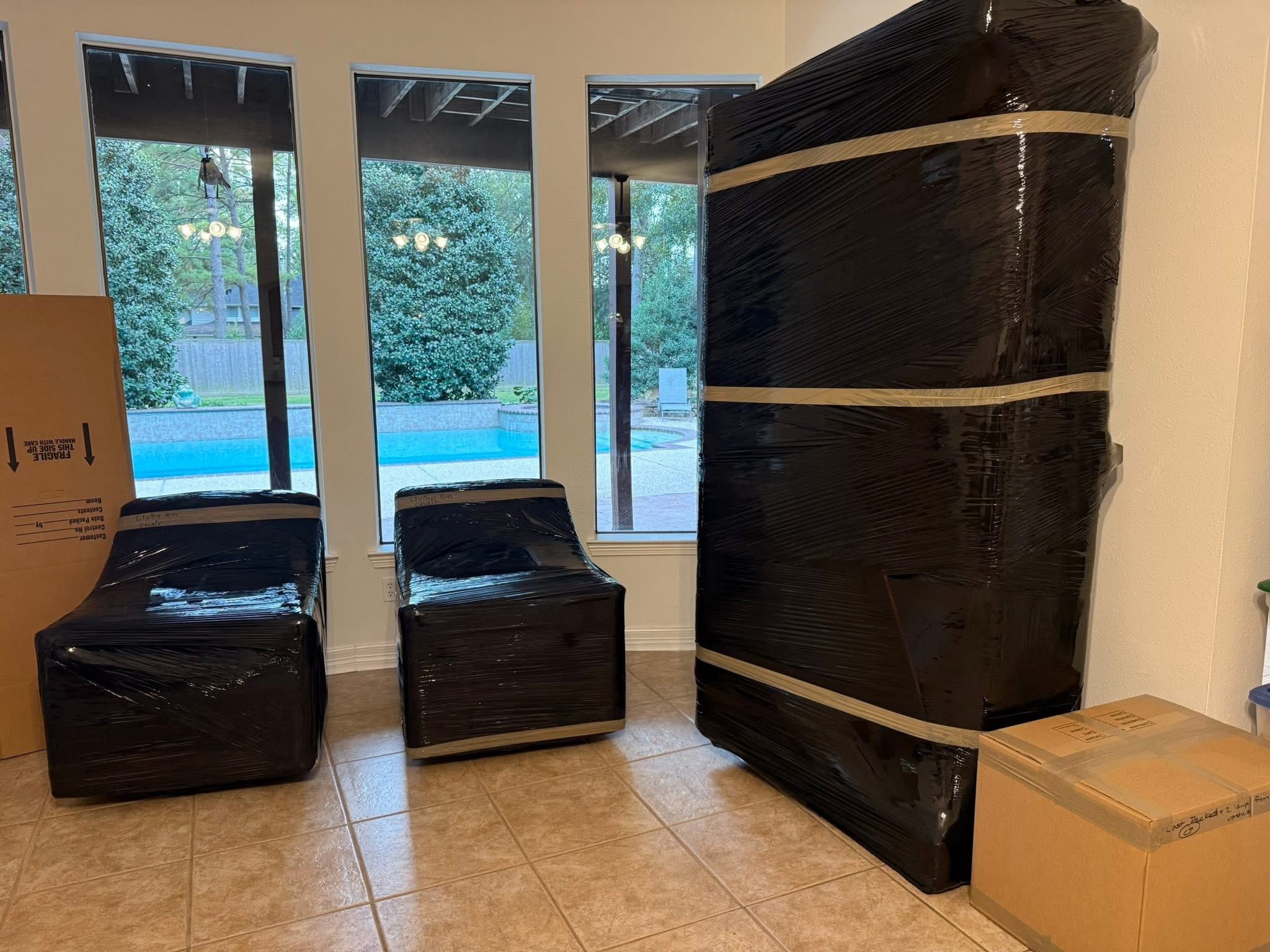 Full service movers wrapping furniture for a move in the McKinney area