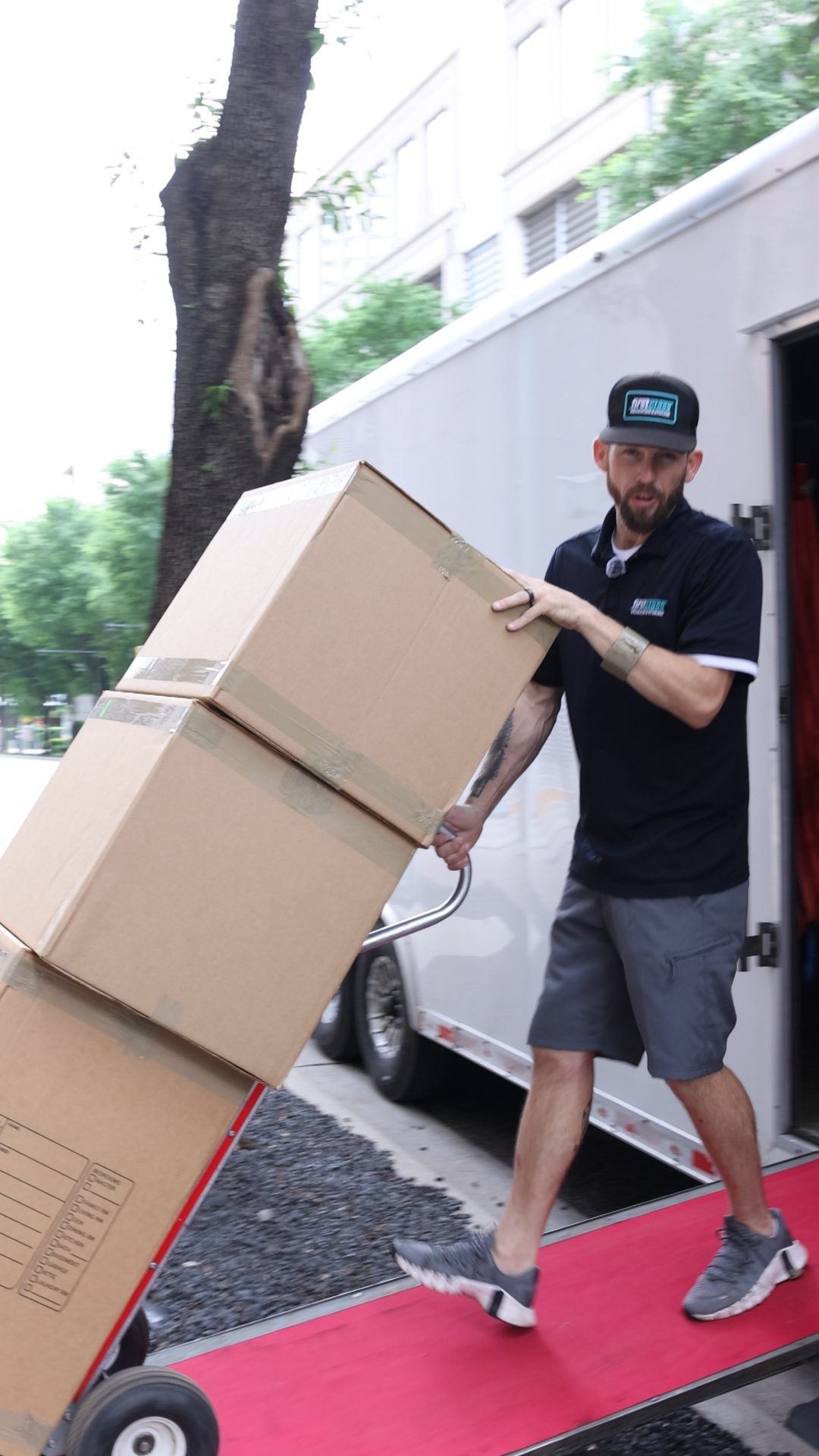 Mover loading boxes on a dolly for a residential move in McKinney TX