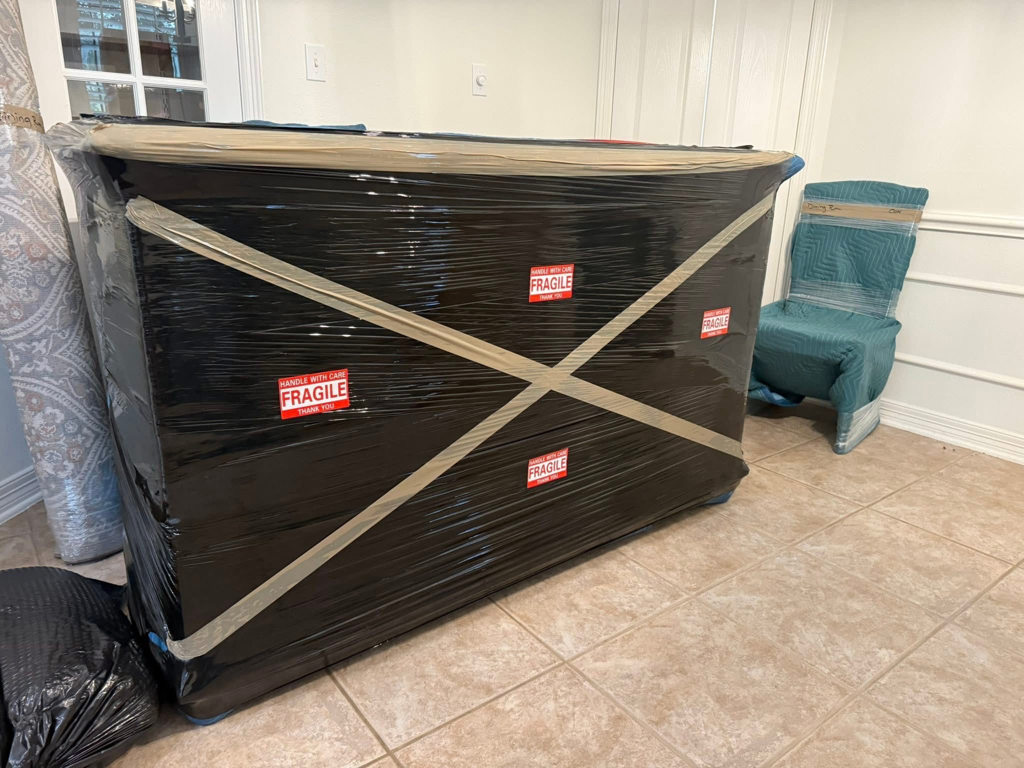 Furniture wrapped in moving blankets by movers in Dallas Fort Worth